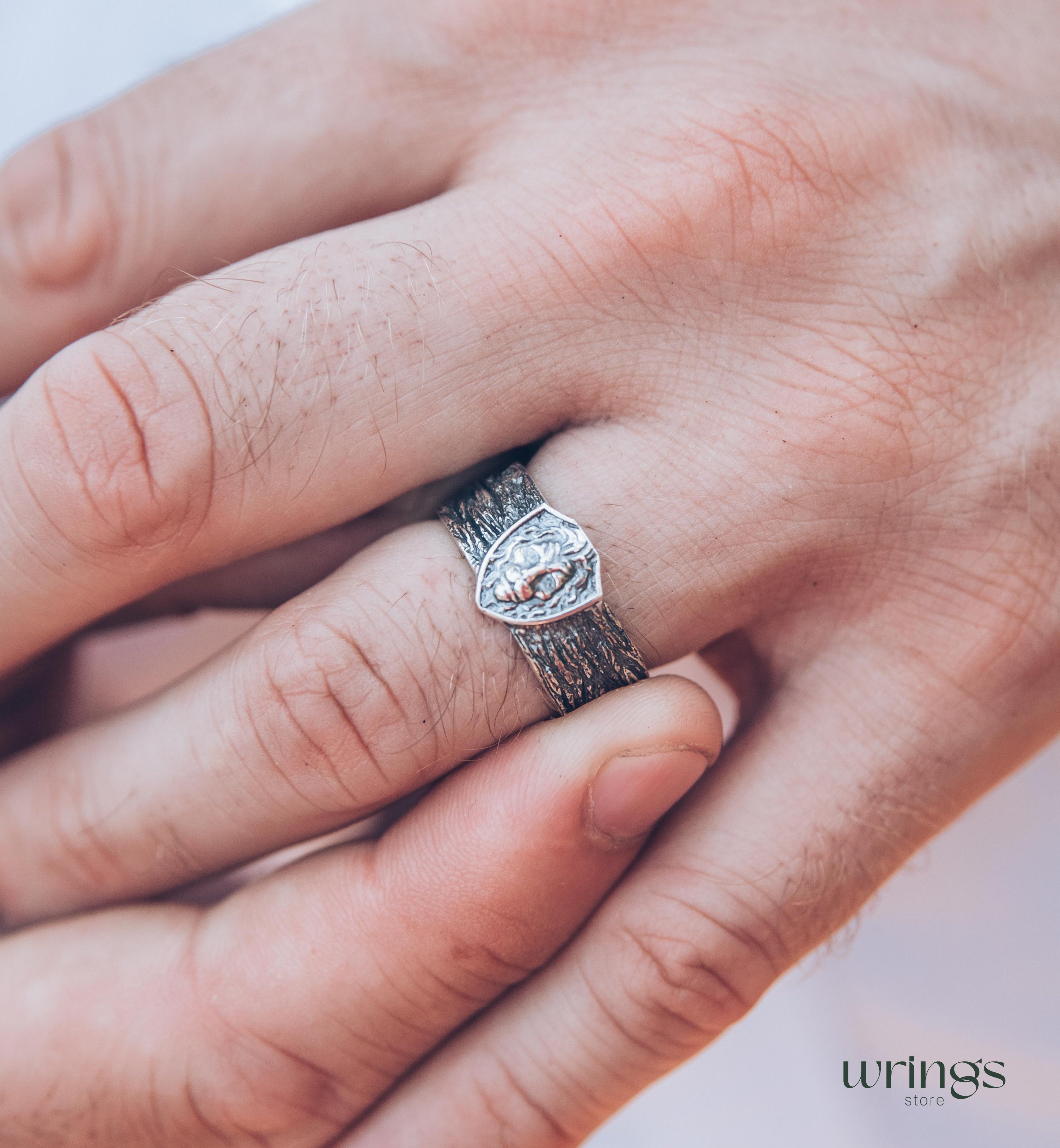 Unique Solid Silver Lion head Ring for Men placed in a Shield