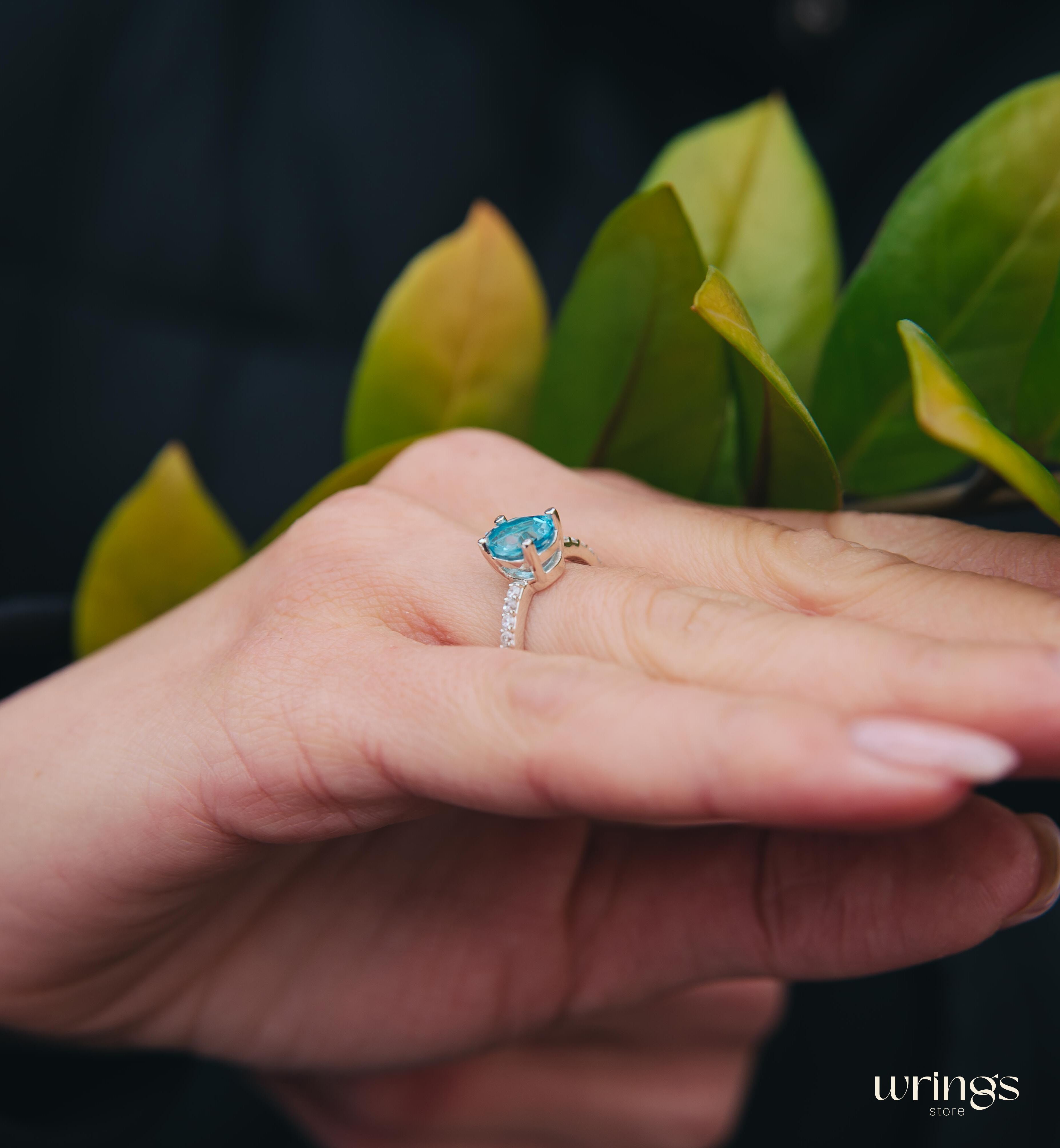 Blue Pear Cut Topaz Engagement Ring & Side CZ Stones