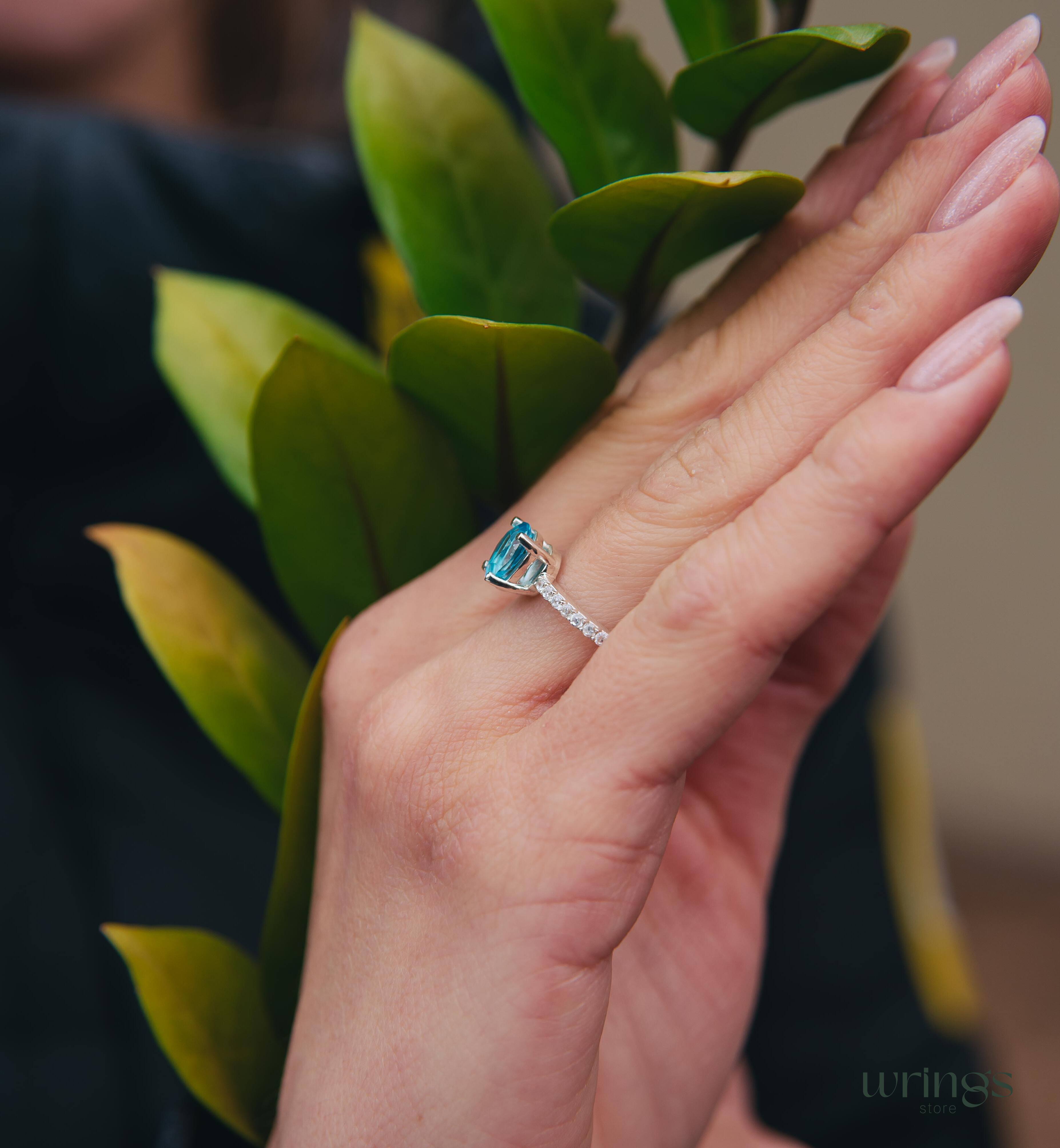 Blue Pear Cut Topaz Engagement Ring & Side CZ Stones