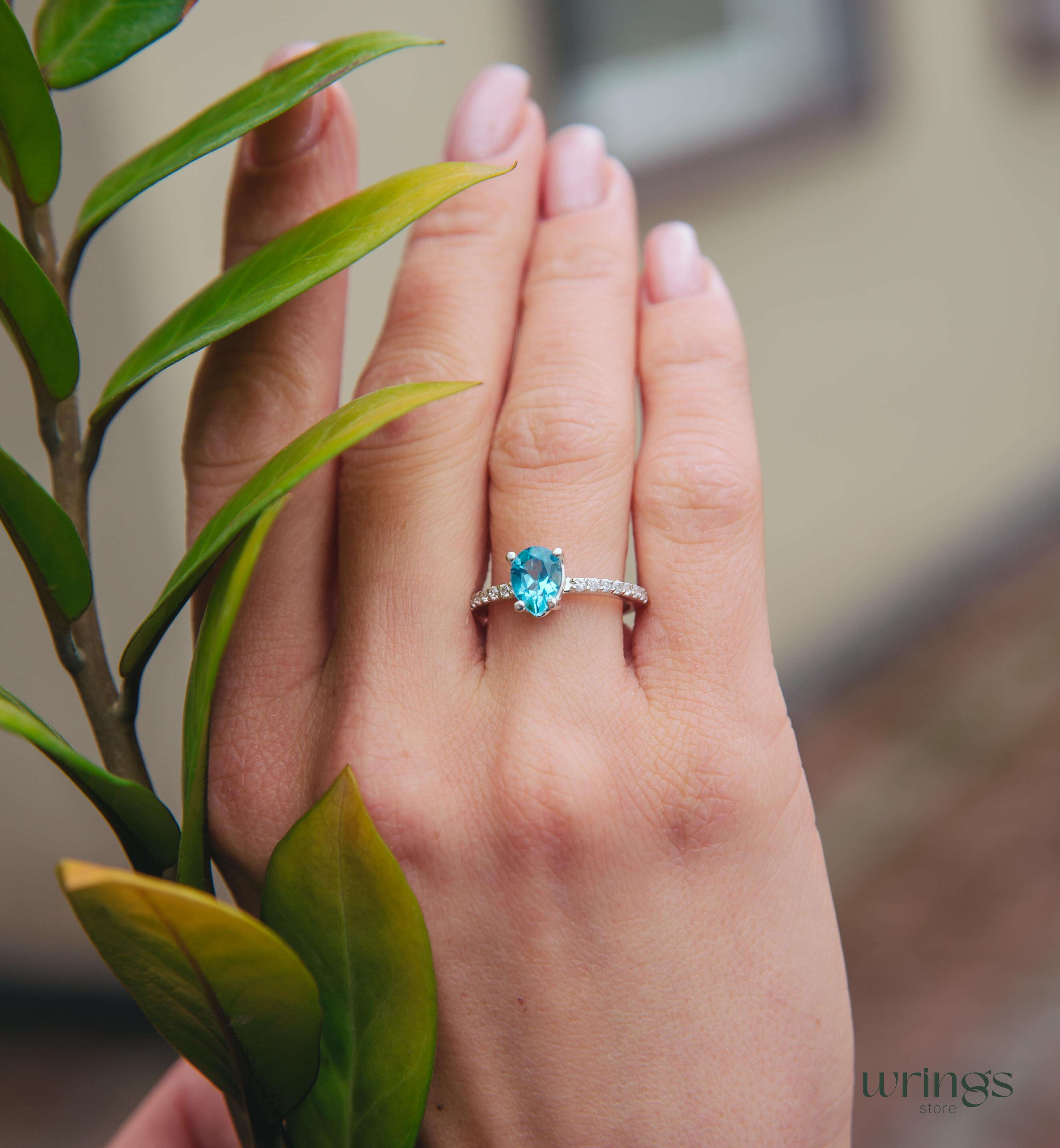 Blue Pear Cut Topaz Engagement Ring & Side CZ Stones