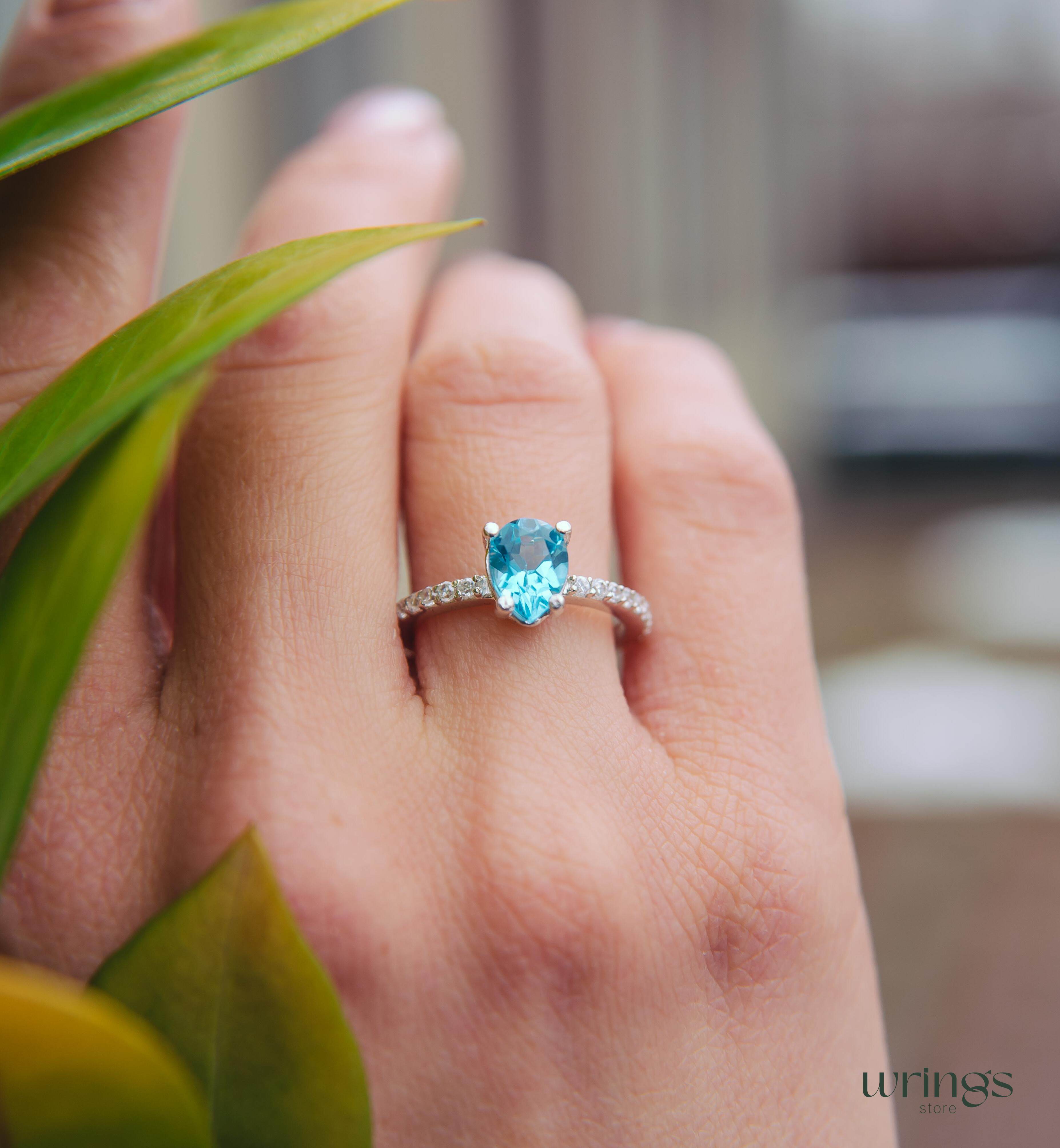 Blue Pear Cut Topaz Engagement Ring & Side CZ Stones