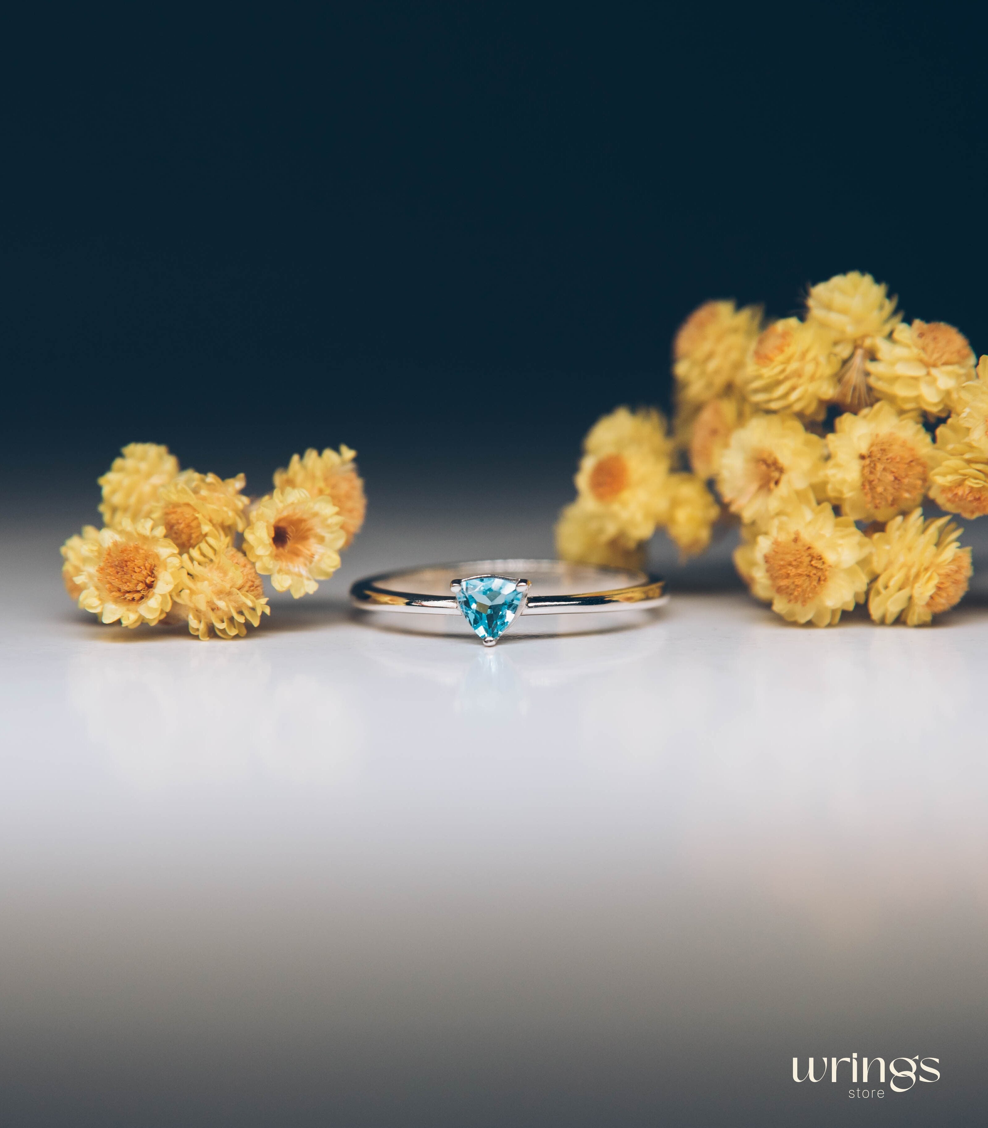 Blue Swiss Topaz Trillion Solitaire Ring in Silver