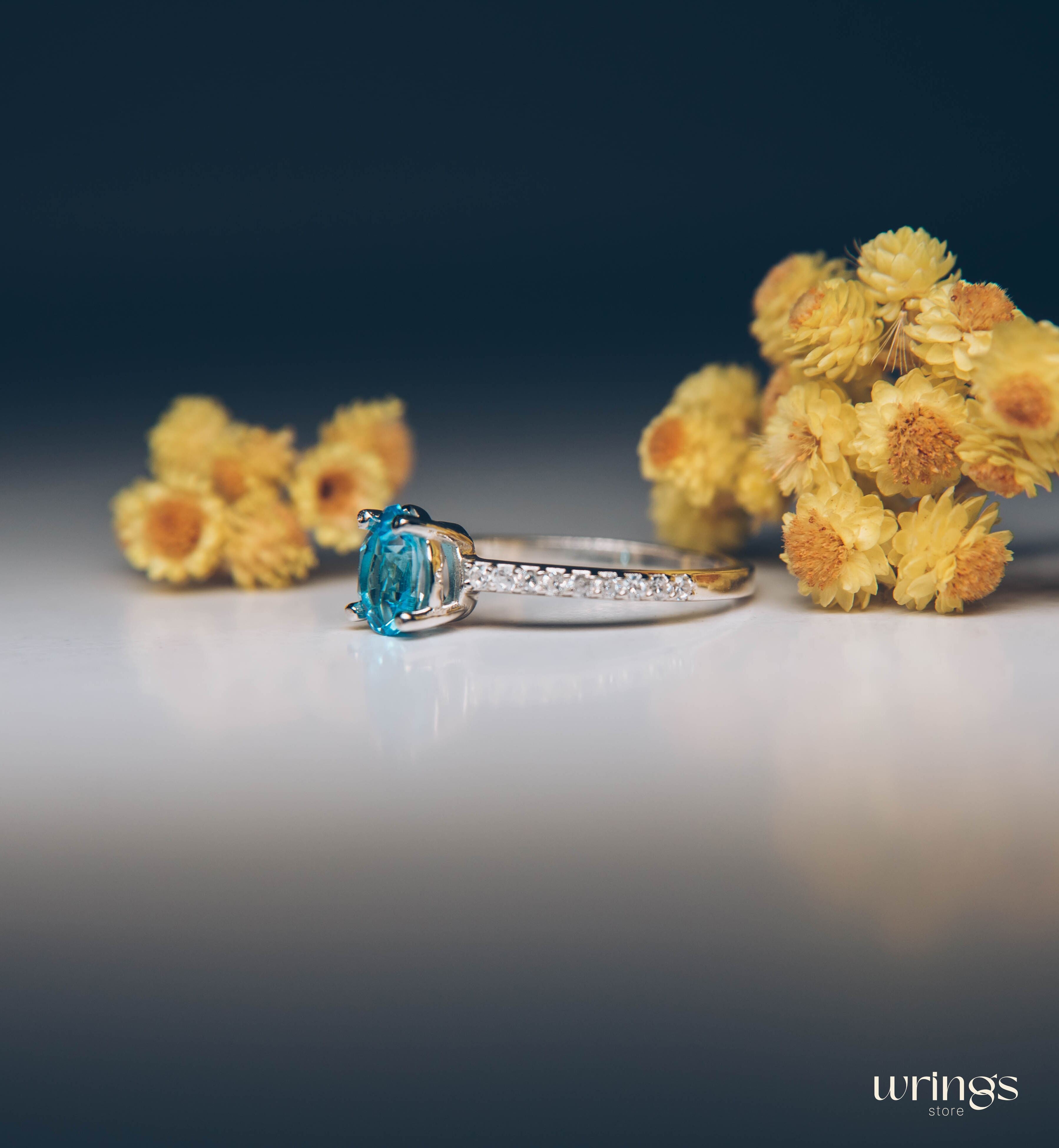 Blue Pear Cut Topaz Engagement Ring & Side CZ Stones