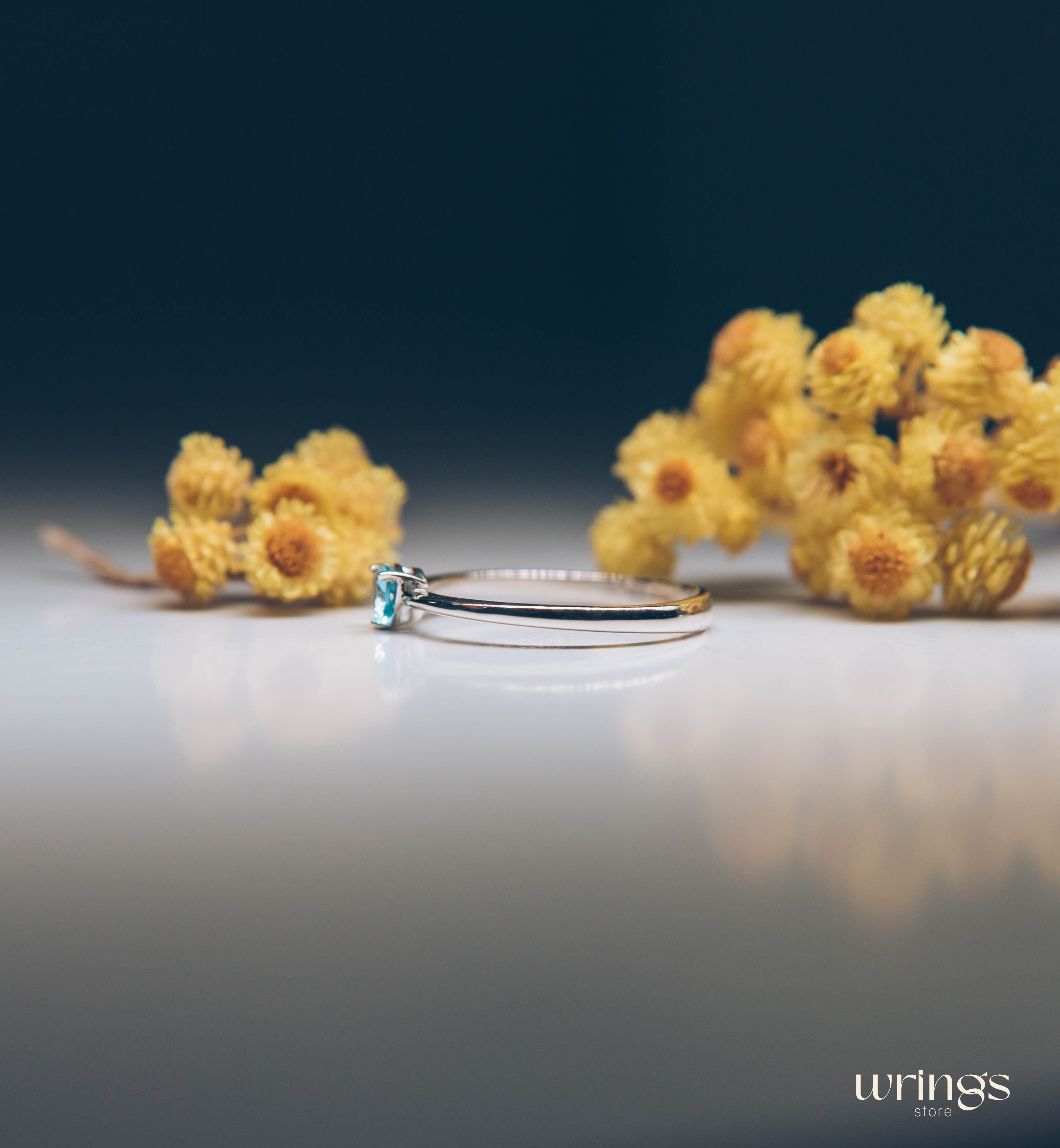 Blue Swiss Topaz Trillion Solitaire Ring in Silver