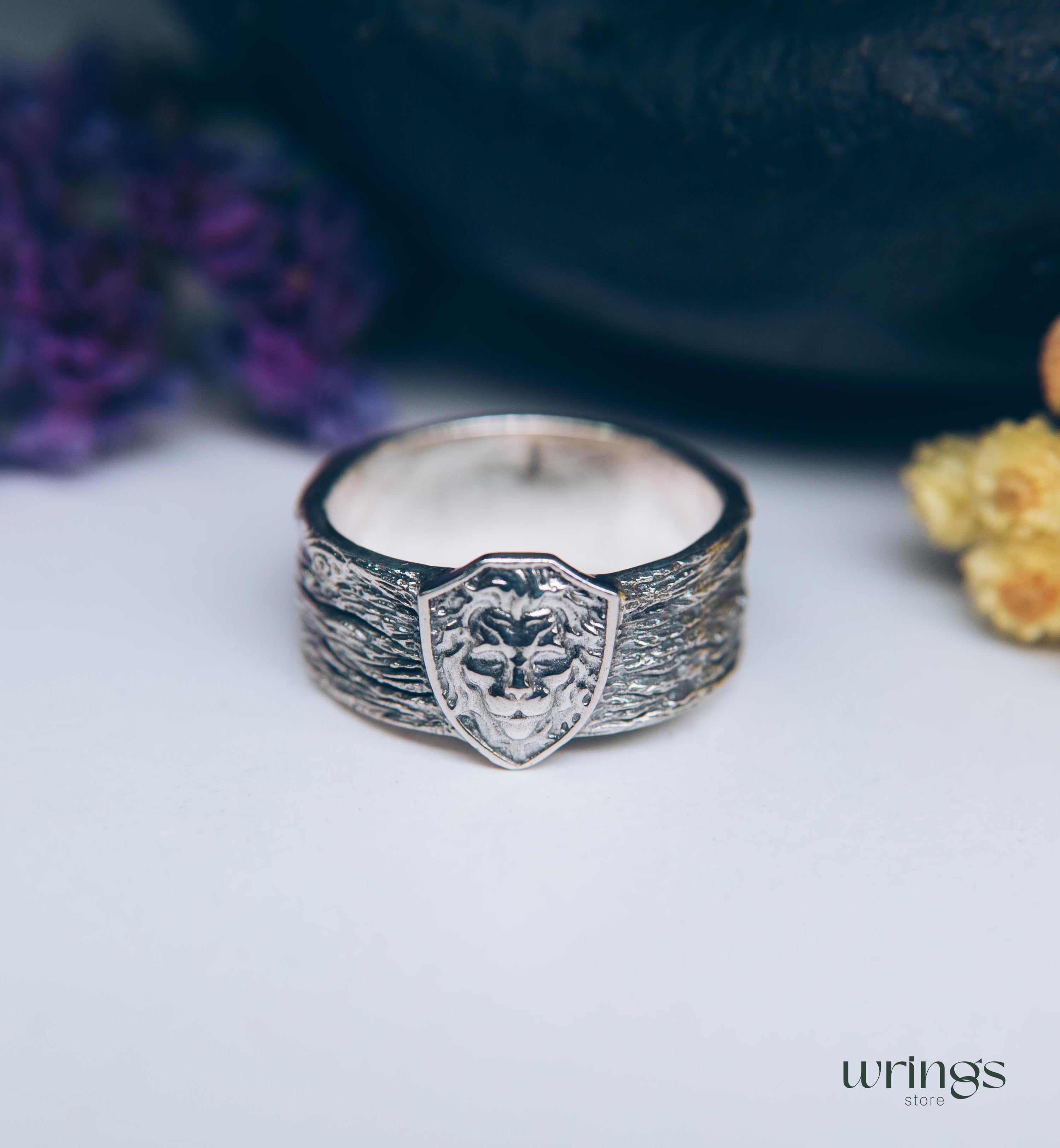 Unique Solid Silver Lion head Ring for Men placed in a Shield