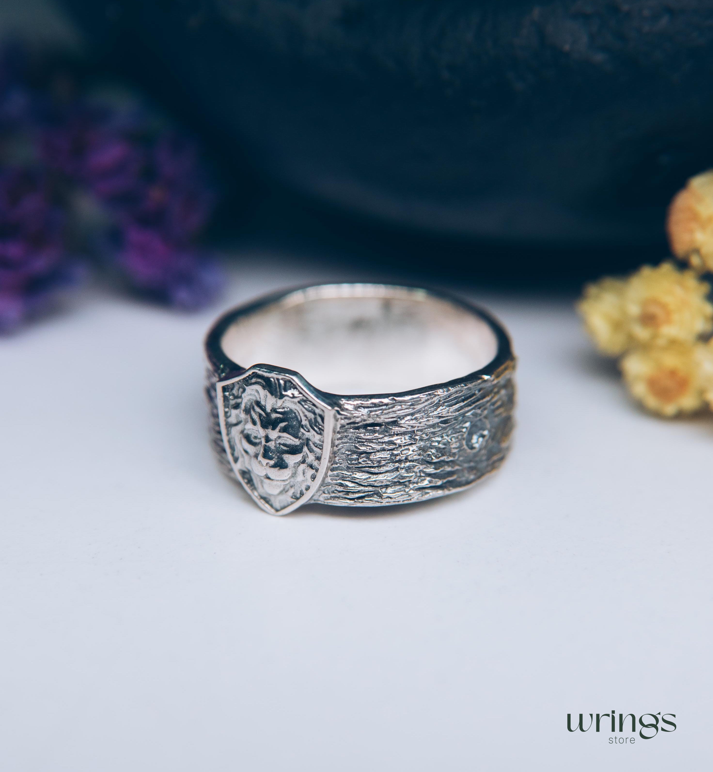 Unique Solid Silver Lion head Ring for Men placed in a Shield