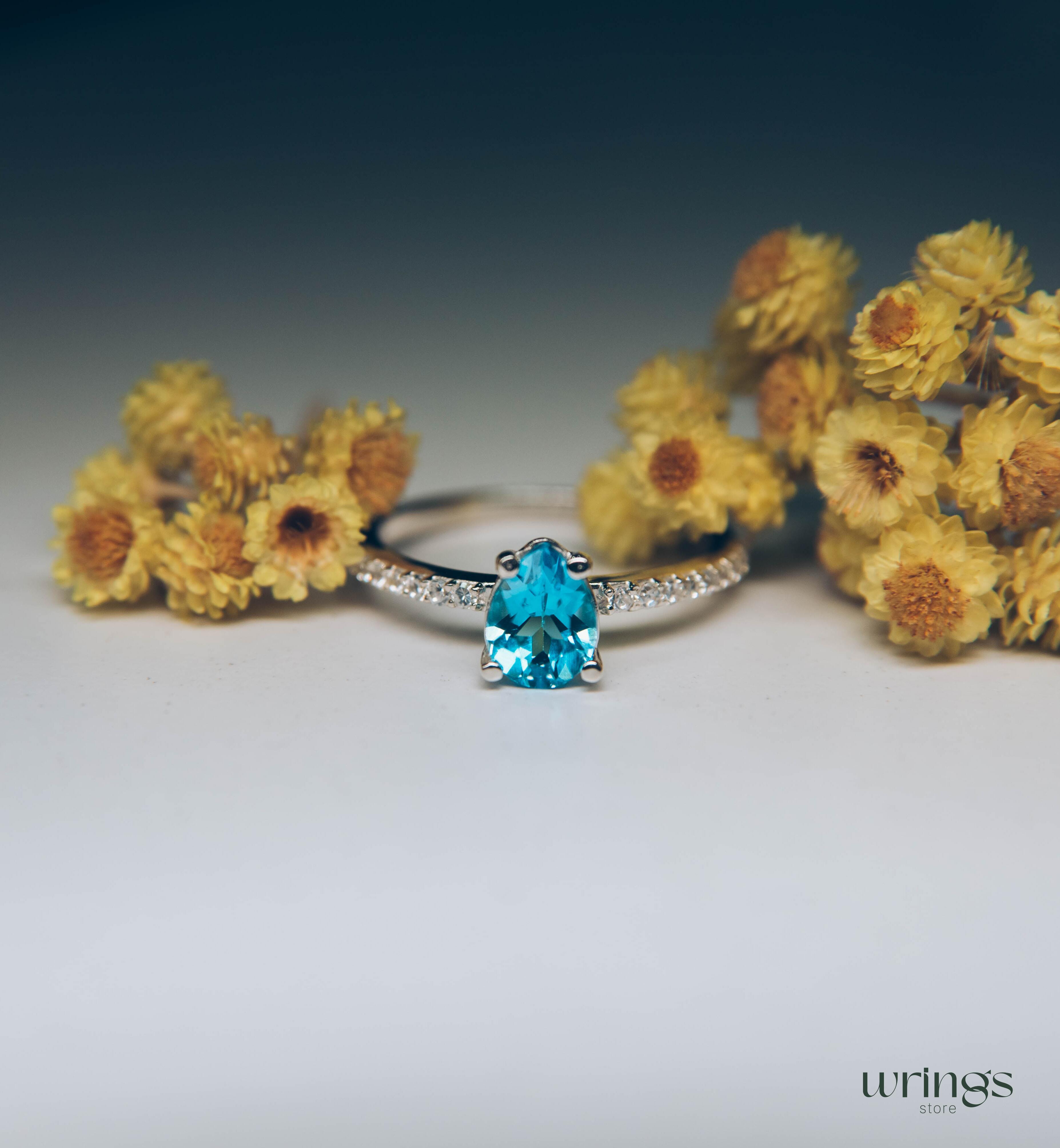 Blue Pear Cut Topaz Engagement Ring & Side CZ Stones