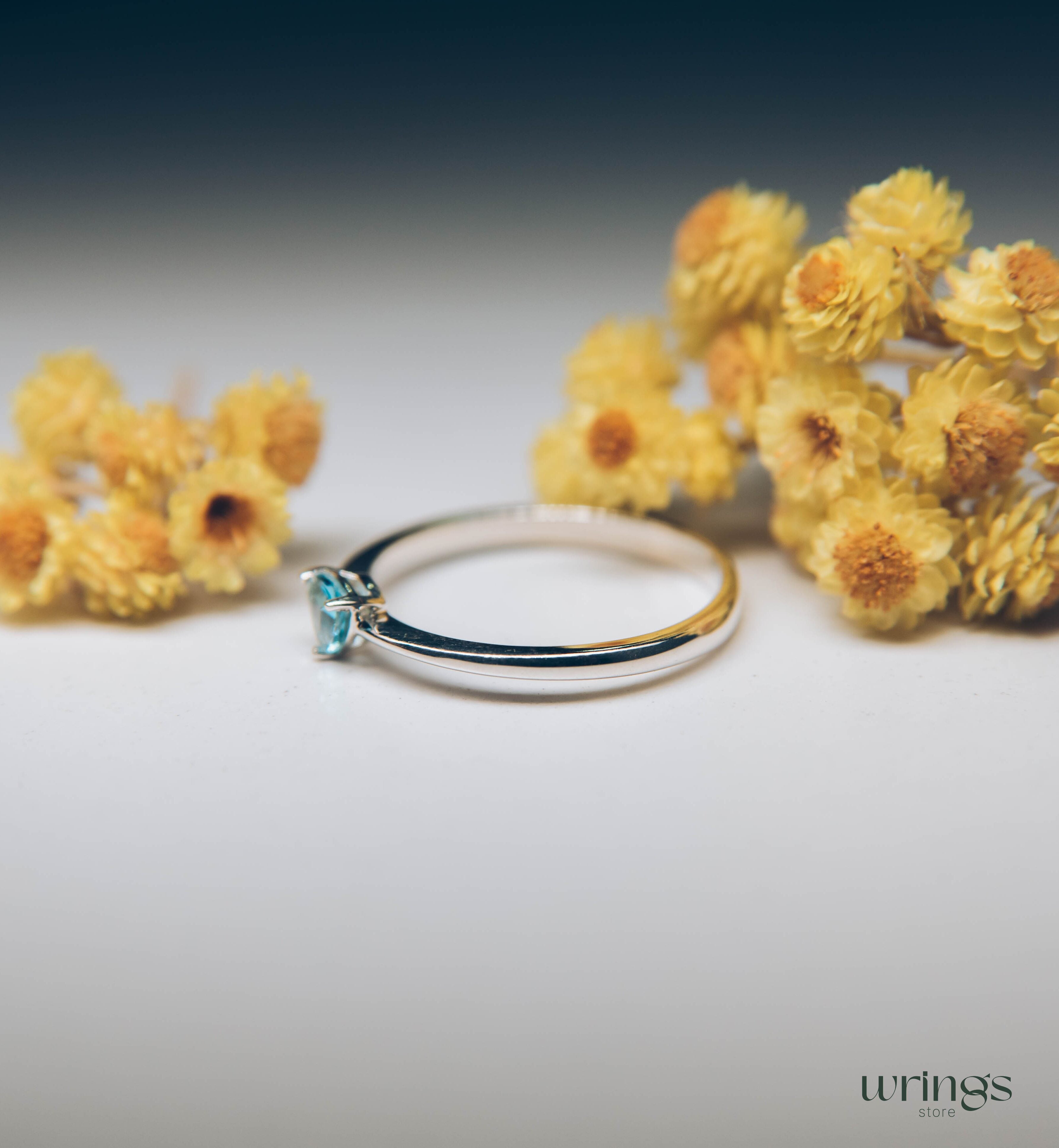 Blue Swiss Topaz Trillion Solitaire Ring in Silver