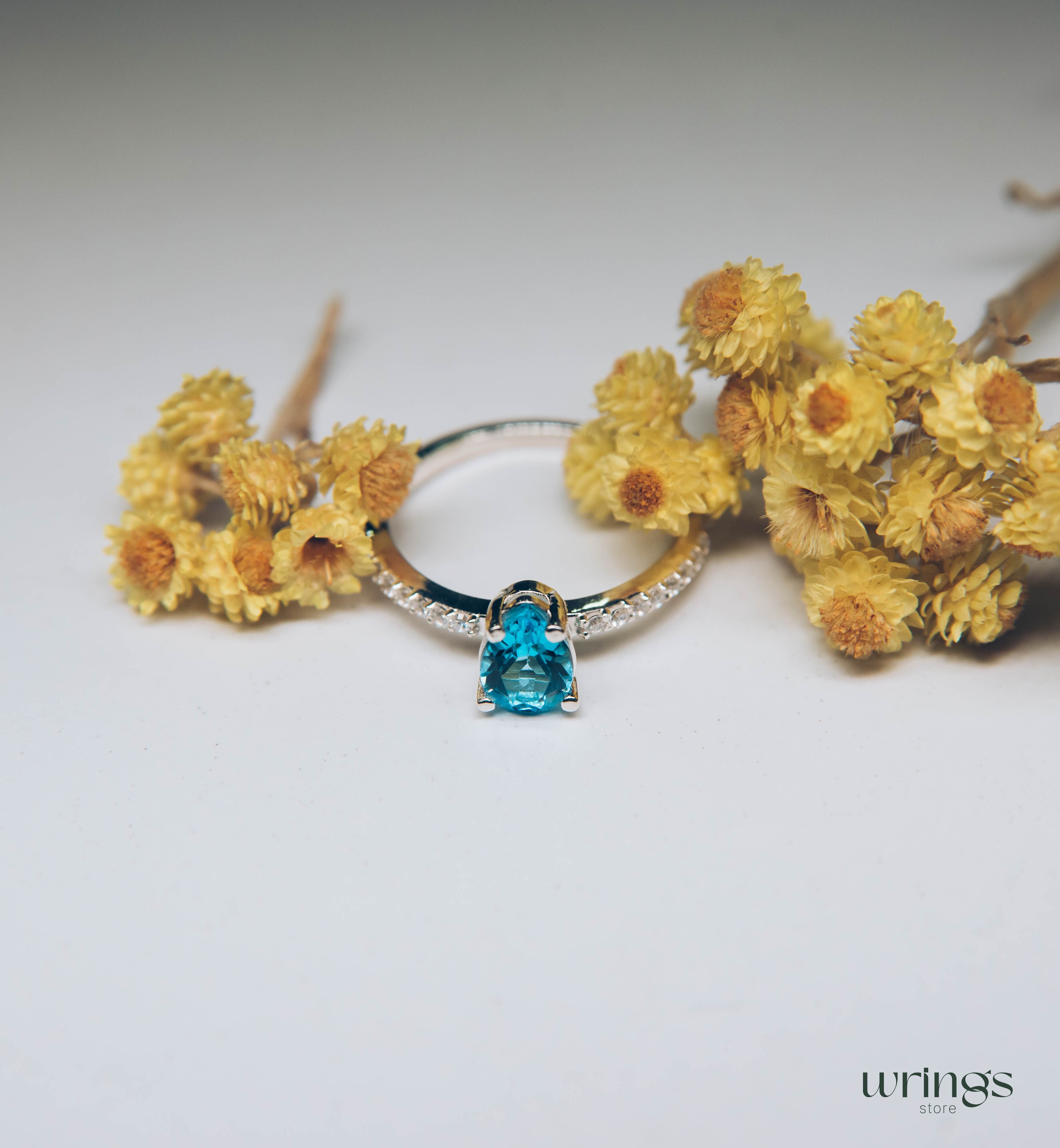 Blue Pear Cut Topaz Engagement Ring & Side CZ Stones