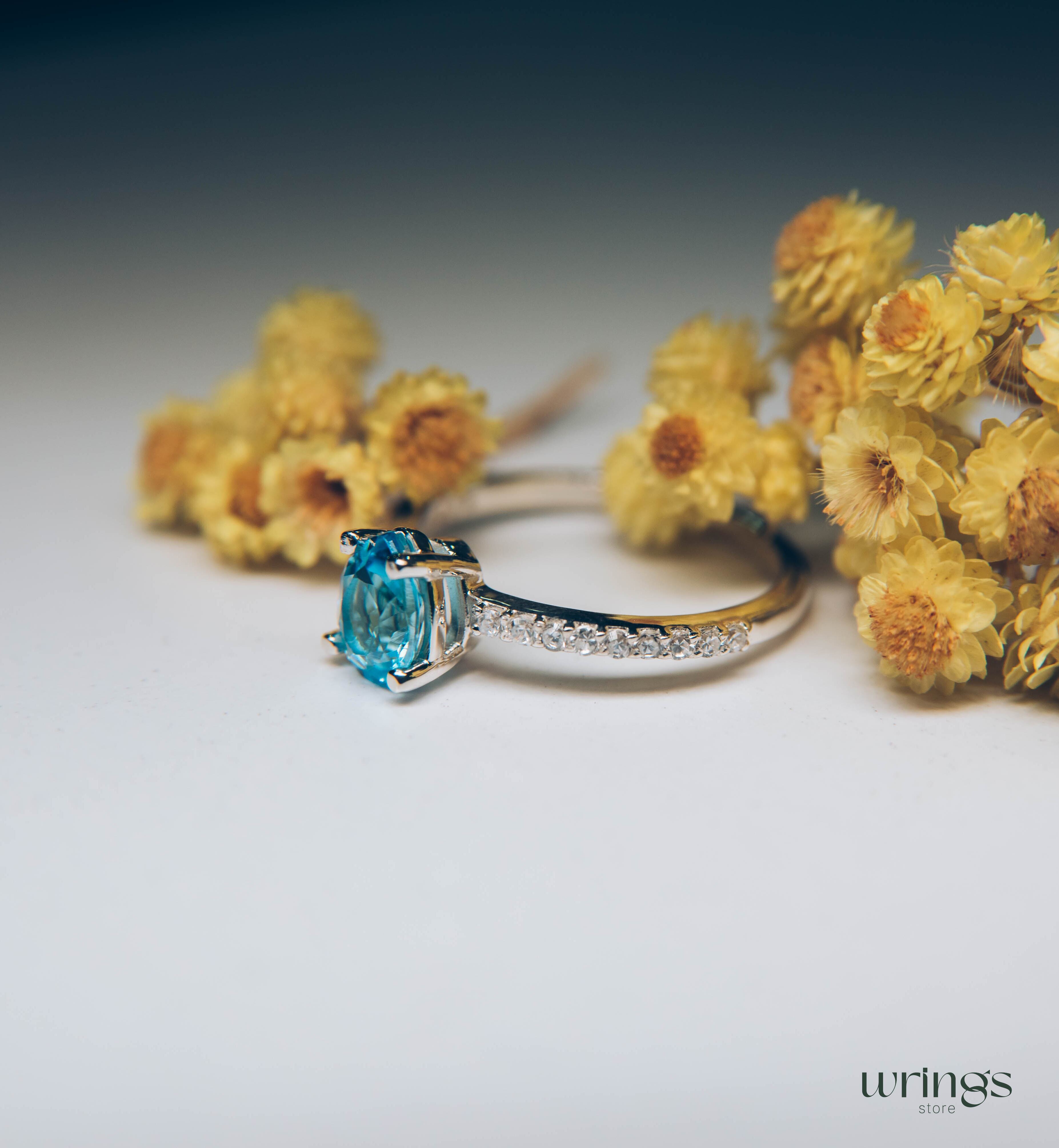 Blue Pear Cut Topaz Engagement Ring & Side CZ Stones