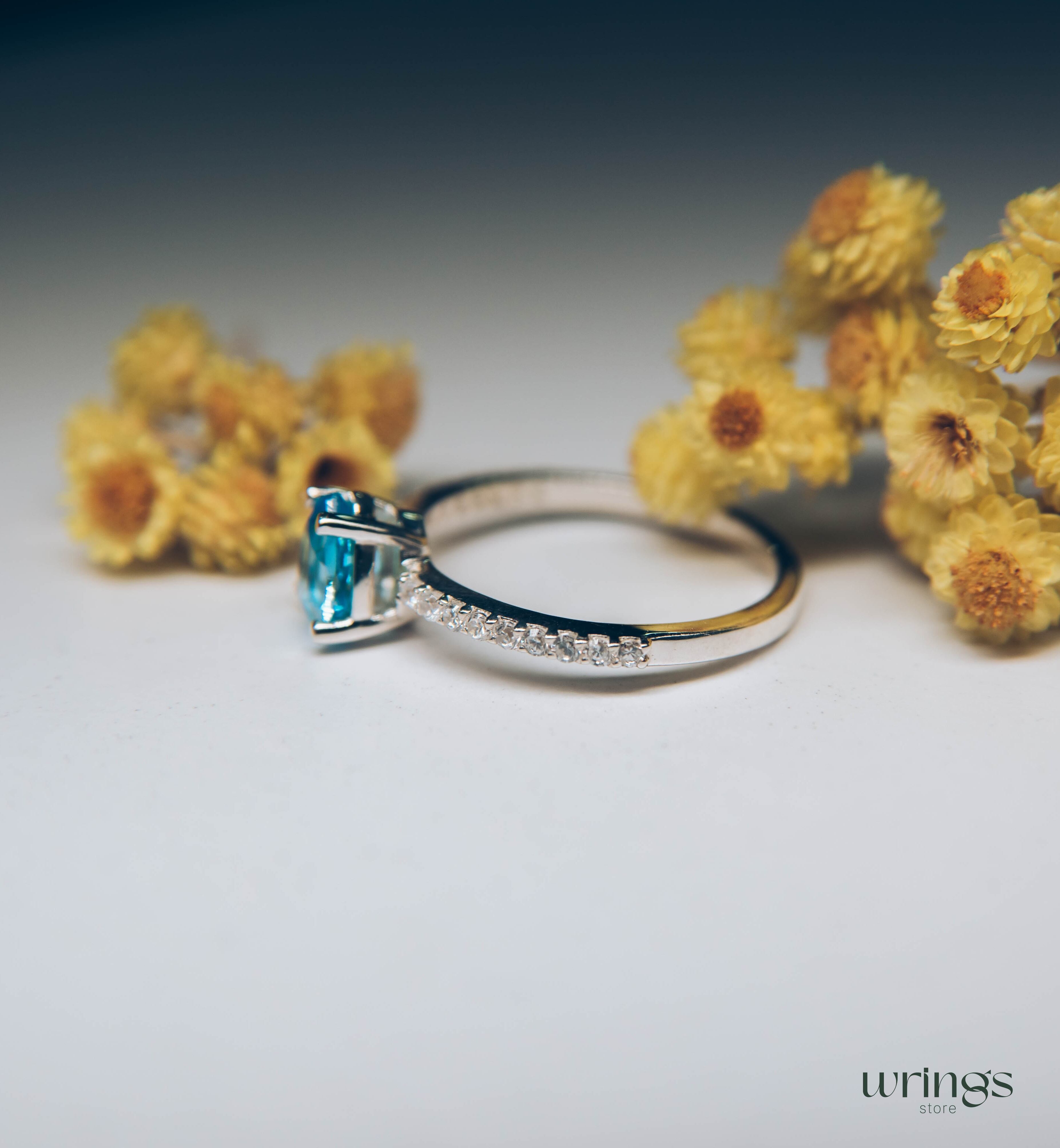Blue Pear Cut Topaz Engagement Ring & Side CZ Stones