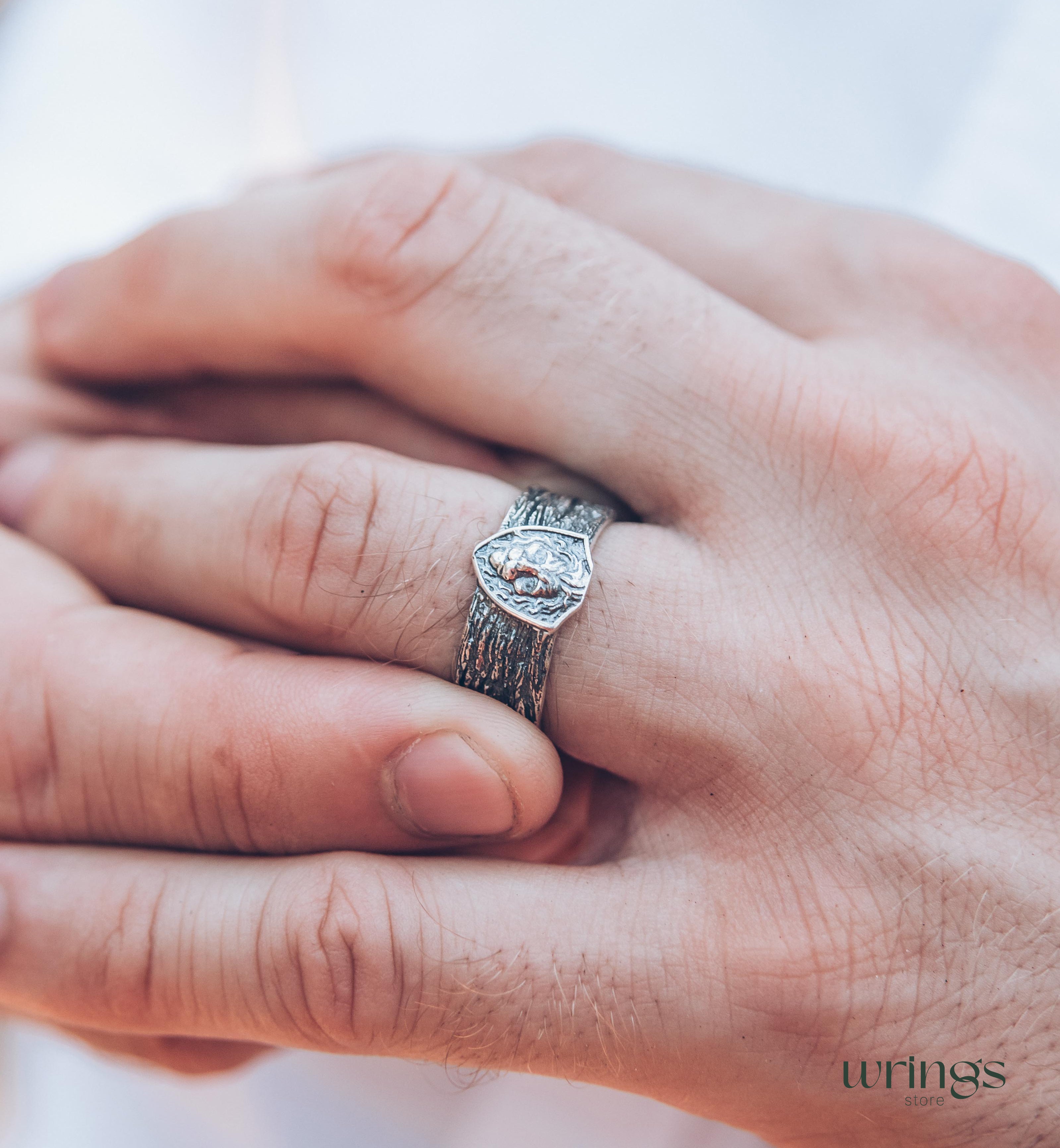 Unique Solid Silver Lion head Ring for Men placed in a Shield