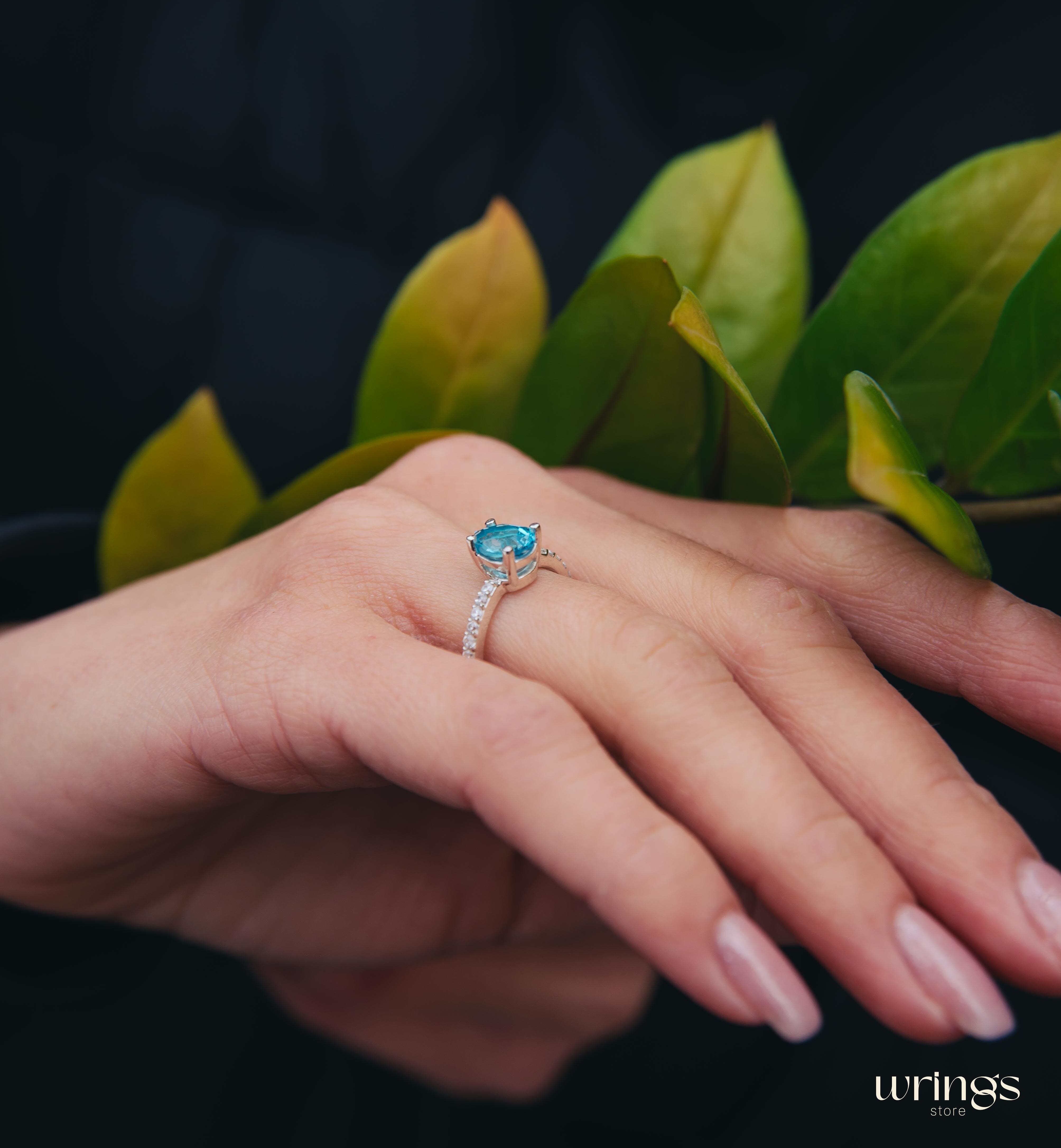 Blue Pear Cut Topaz Engagement Ring & Side CZ Stones