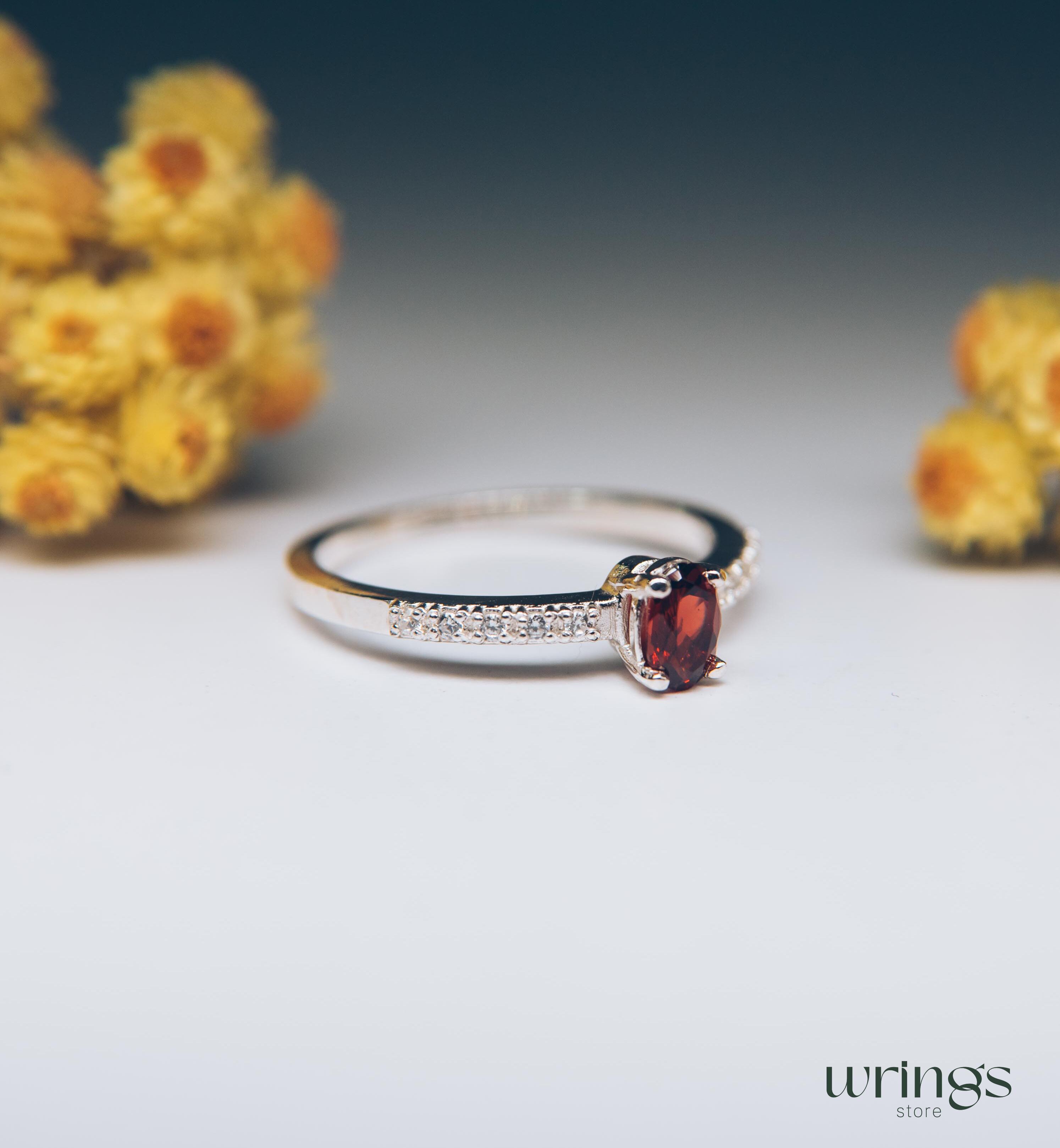 Red Oval Garnet Silver Ring with White Side Stones