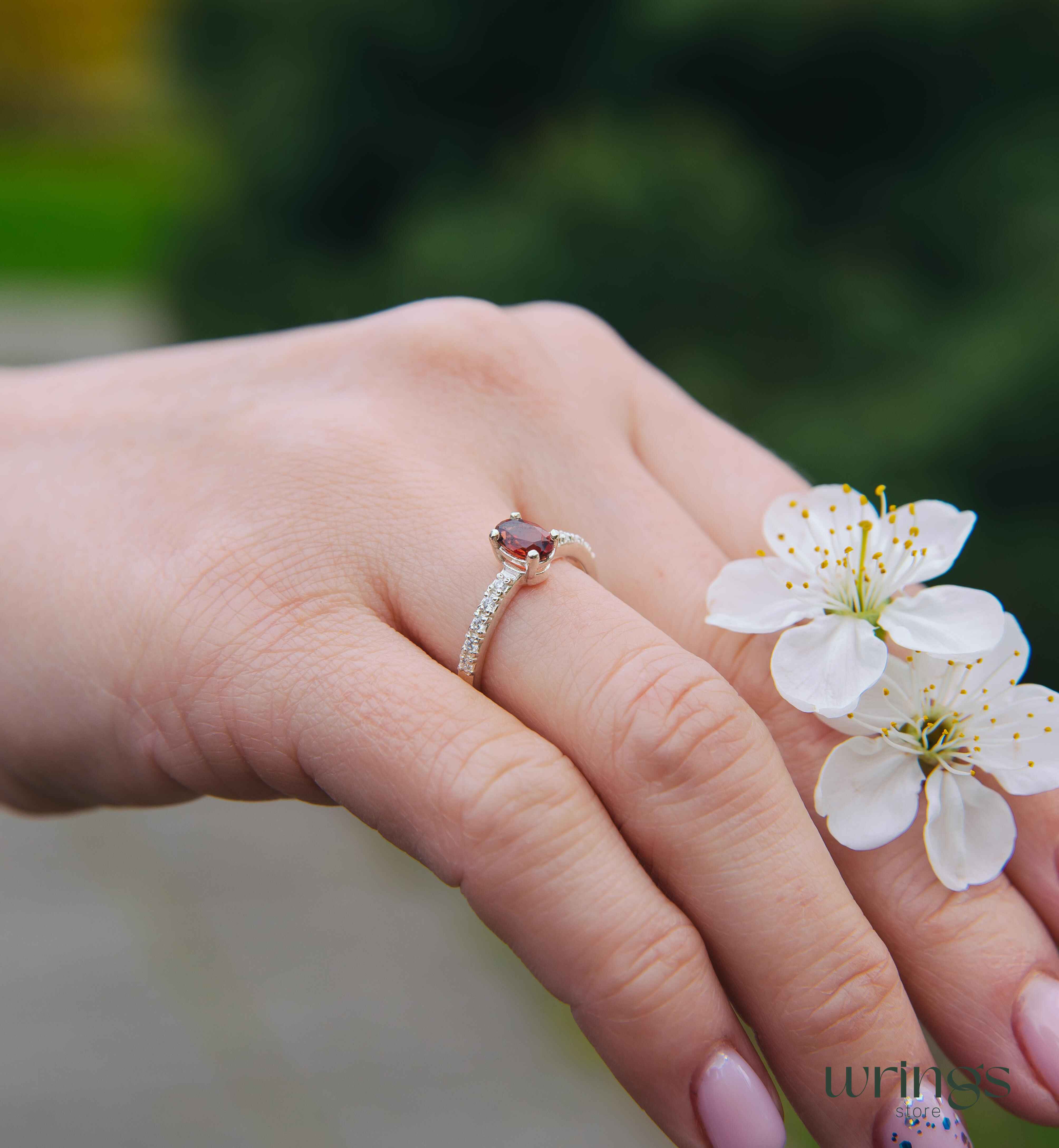 Red Oval Garnet Silver Ring with White Side Stones