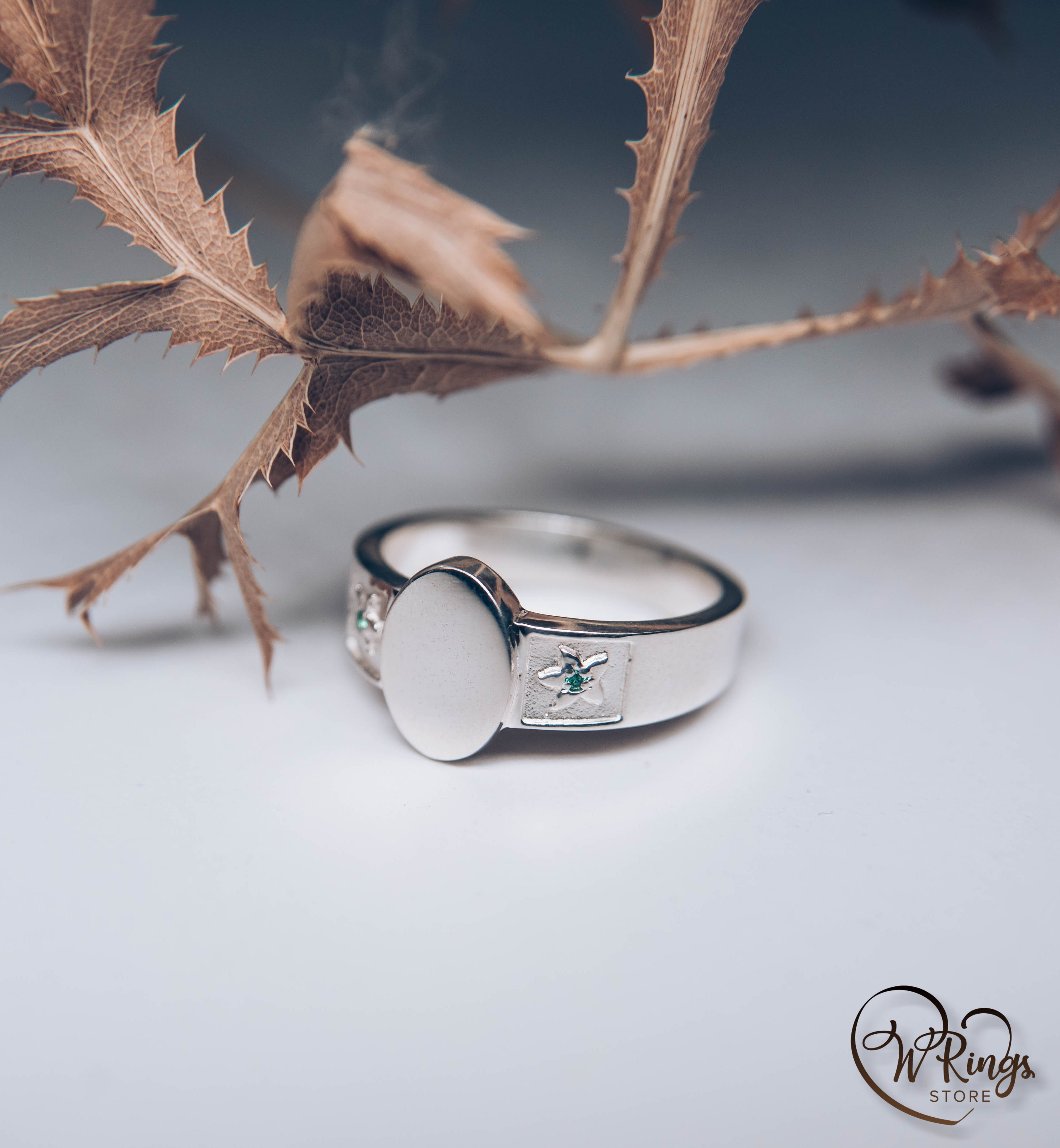 Oval shape & Emeralds in Side Flowers Signet Ring made in Silver