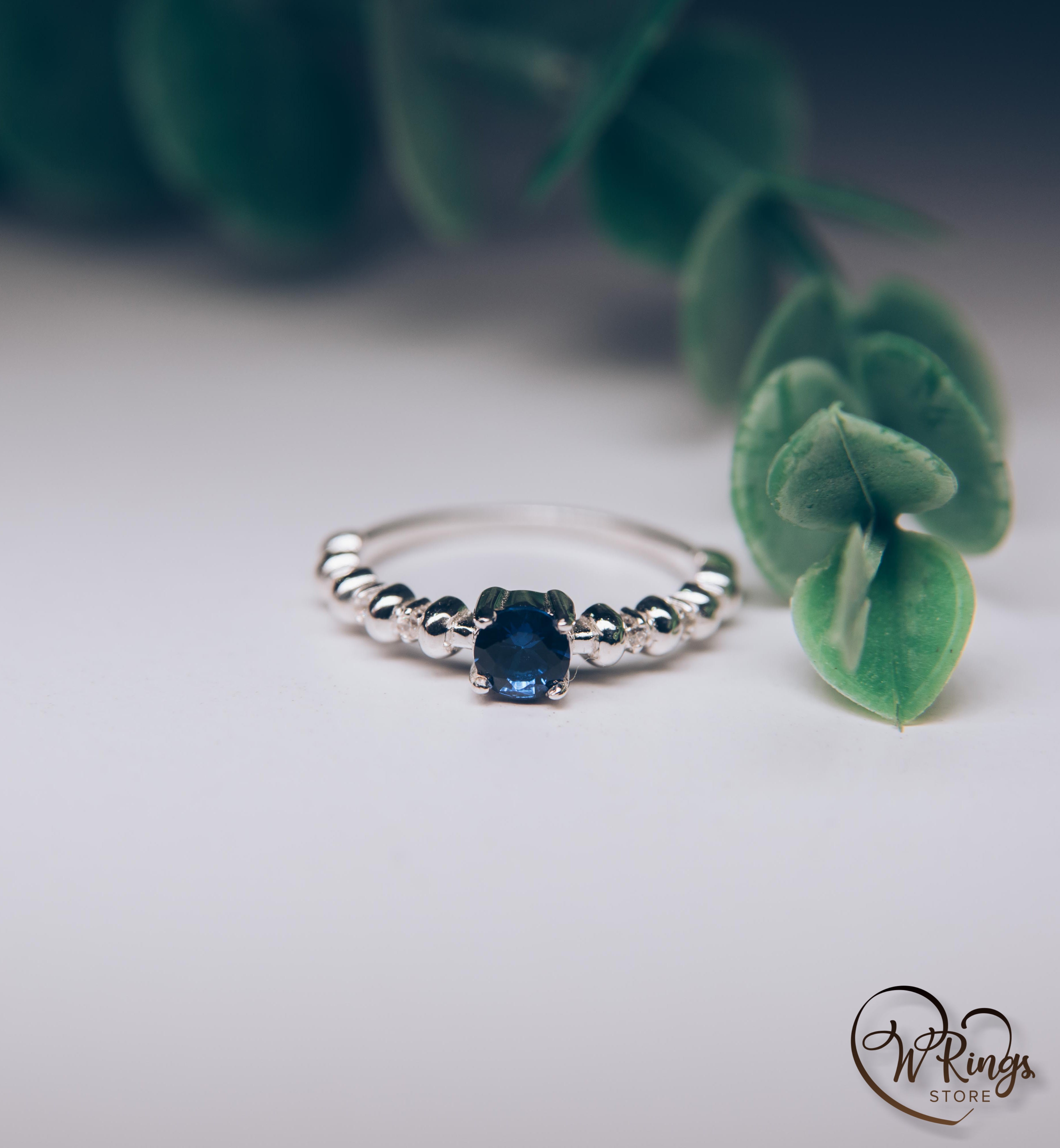 Round Sapphire & Side Stones Engagement Ring with bubbles on band