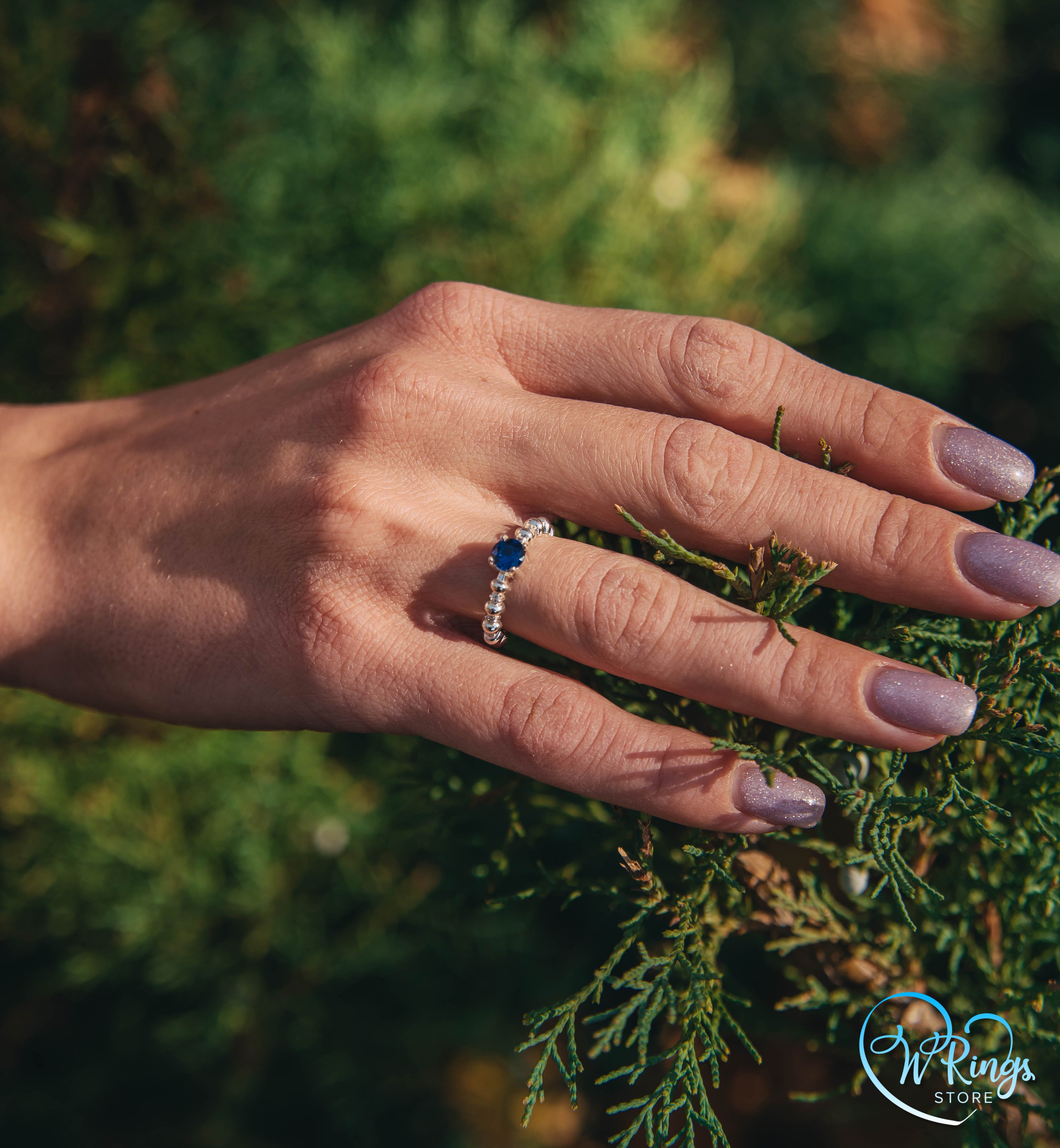 Round Sapphire & Side Stones Engagement Ring with bubbles on band