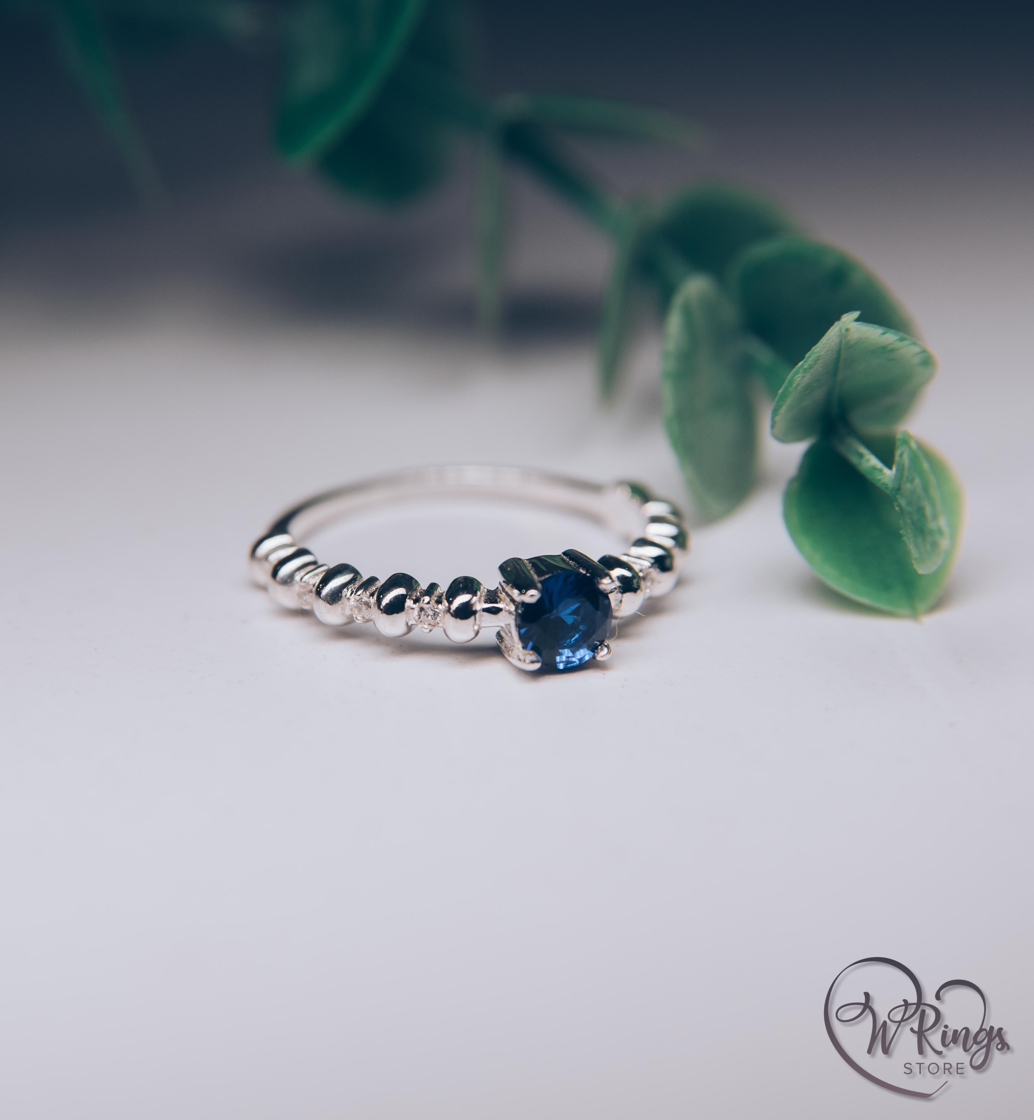 Round Sapphire & Side Stones Engagement Ring with bubbles on band