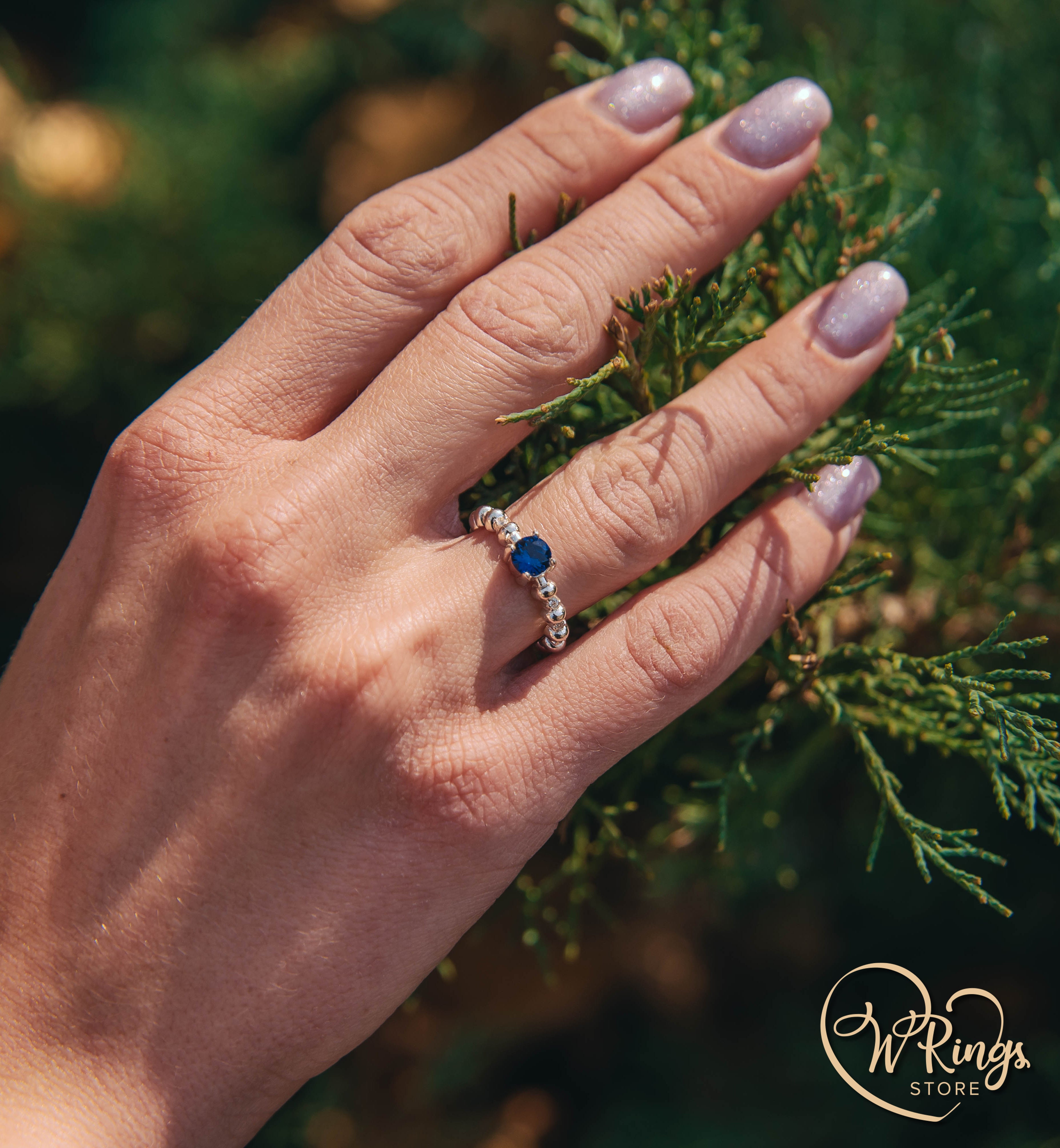 Round Sapphire & Side Stones Engagement Ring with bubbles on band