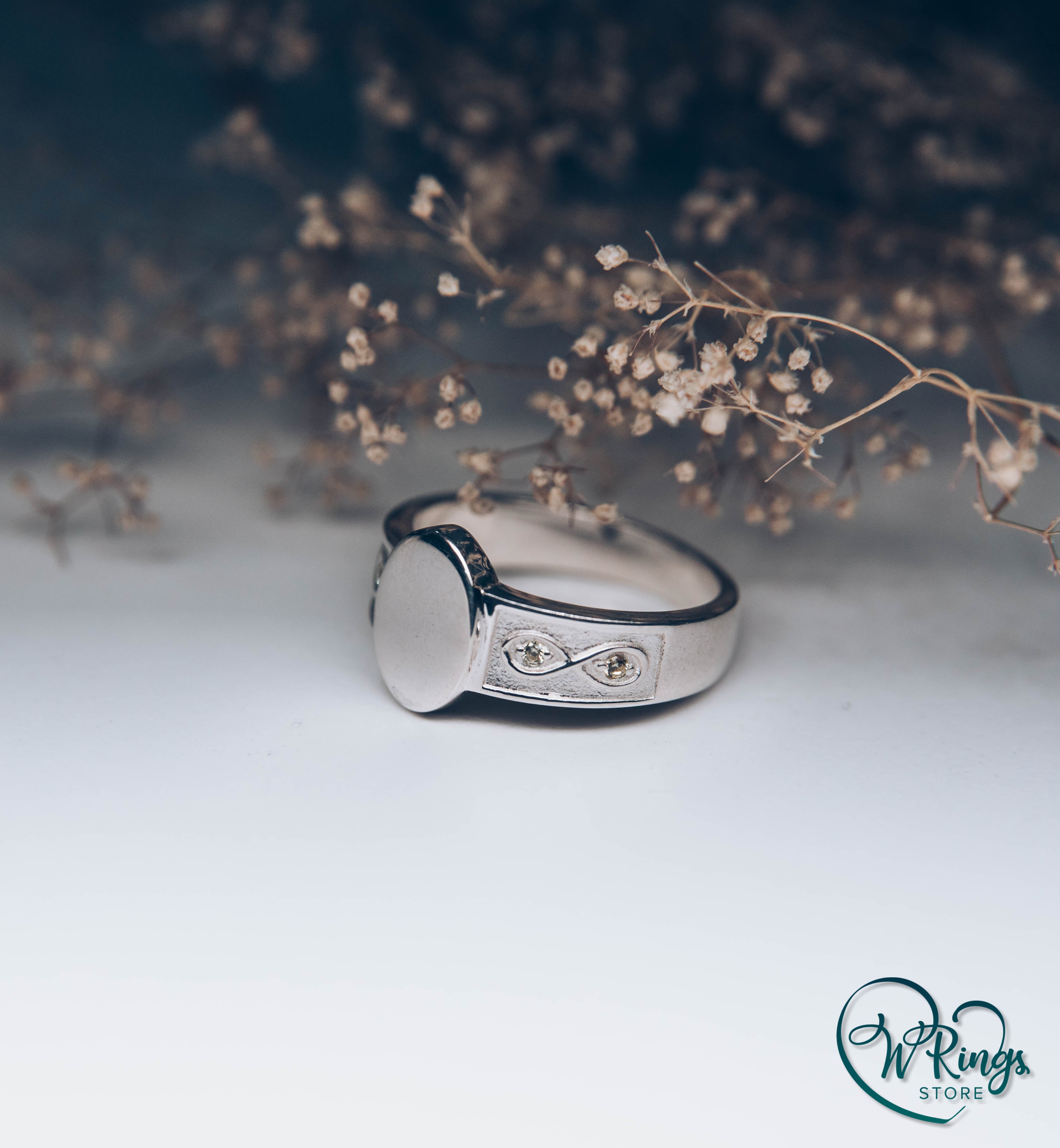 Side Infinity symbol on Silver Oval Signet Ring with small Gemstones